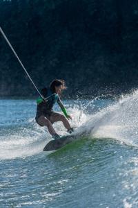 a person on a surfboard in the water at Zab Living in Vila de Rei