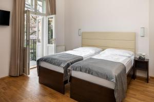 Postel nebo postele na pokoji v ubytování Hotel Unique