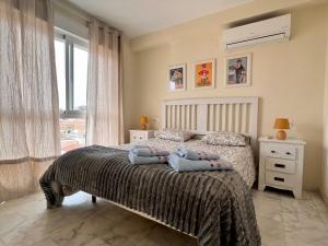 a bedroom with a bed with two pillows on it at BE-Berrocal in Málaga