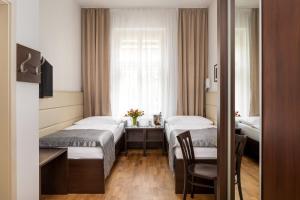 Postel nebo postele na pokoji v ubytování Hotel Unique