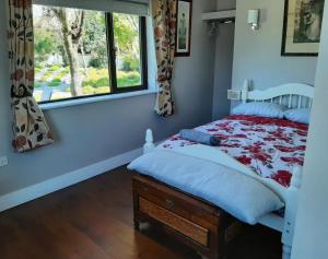a bedroom with a bed and a window at Watervalley Farm Self Catering in Cloongawn
