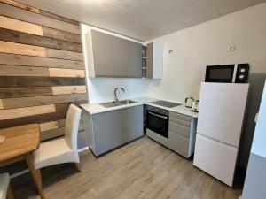 a small kitchen with a sink and a refrigerator at Cosy 2-bedroom flat in Selfoss