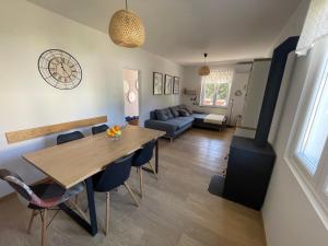 a dining room and living room with a table and chairs at Holiday Home Lola - large outdoor area in Starigrad