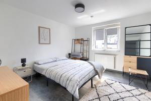 a bedroom with a bed and a dresser and a window at Saint Maurice Design Home in Stiring-Wendel