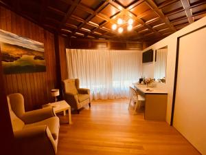a living room with a table and chairs and a window at Vendaval in Santa Marta de Ortigueira