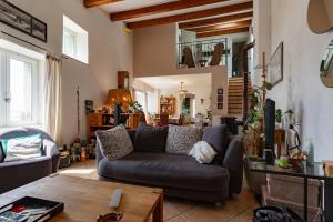 a living room with a couch and a table at La Villa du bonheur in Puy-Saint-Martin