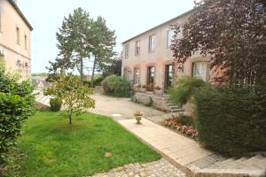 a house with a fire hydrant in the middle of a yard at Hôtellerie Saint Yves in Chartres