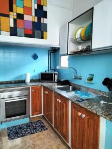 a kitchen with a sink and a stove top oven at Avenida Marítima Trapiche in Santa Cruz de la Palma
