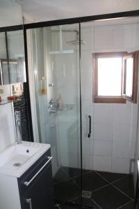 a bathroom with a glass shower and a sink at Les Capellans, port d'attache in Saint-Cyprien-Plage +25 photos