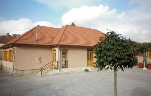 a house with a red roof and a tree at Anna Vendégház Tarcal in Tarcal