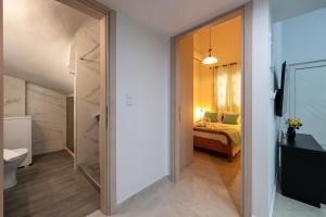 a hallway leading to a bedroom with a bed at Sophia's Apartment in Kalamata