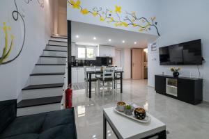 a living room and kitchen with a staircase in a house at Sophia's Apartment in Kalamata
