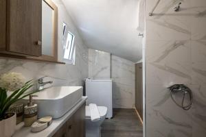 a bathroom with a sink and a toilet at Sophia's Apartment in Kalamata