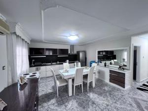 a kitchen with a table and chairs in a room at Narcis House in Thessaloniki