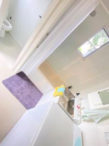 an attic room with a sink and a window at The Nook - Kerikeri in Kerikeri