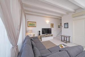 Televízia a/alebo spoločenská miestnosť v ubytovaní Resort Caesar C4 Sirmione - Gardagate + 34 fotografií