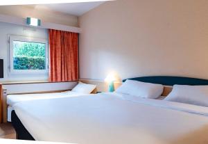 Postel nebo postele na pokoji v ubytování B&B HOTEL Grenoble Université 2