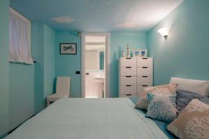 a bedroom with blue walls and a bed with pillows at Casa al Castello in Lerici