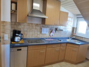 a kitchen with a sink and a stove top oven at Ferienwohnung in Rheinstetten