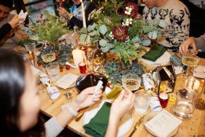 a group of people sitting at a table with a table centerpiece at Large Penthouse by Damask Homes with Parking in Redbridge