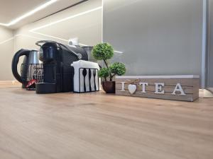 a room with a coffee maker and plants on the floor at Premium Central Skopje Apartments & Free Private Parking in Skopje +2 photos