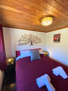 a bedroom with a purple bed with a wooden ceiling at Otter 2 HuntersMoon- Warminster-Wiltshire-Bristol in Warminster +15 photos