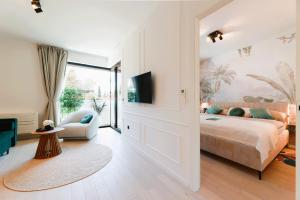 a bedroom with a king sized bed and a tv at Ars Vivendi in Opatija