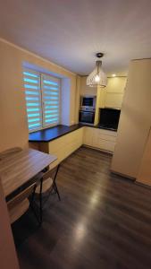 an empty kitchen with a table and a window at Patogus poilsis in Ignalina