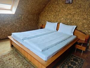 a bedroom with a large bed with blue sheets at Hotel Christine in Târgu Secuiesc +108 photos