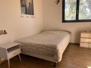 Un dormitorio pequeño con una cama y una mesita de noche. en Villa Natura, en Saint-Jean-de-Cuculles 13 fotos más