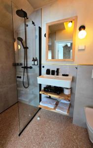 a bathroom with a sink and a shower at ONGA Boutique Lodge in Alta