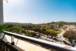 a view of a city from a balcony at A holiday Home in Gozo Right by the Sea in Marsalforn