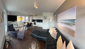 a living room with a couch and a dining room at Hering in Scharbeutz