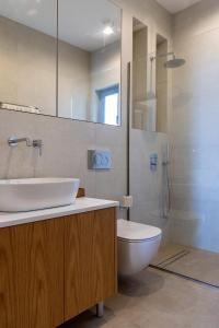 a bathroom with a sink and a toilet at Blu in Tinos Town +22 photos