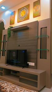a flat screen tv in a living room at Dee Riverside Homestay airport kota Bharu in Kota Bharu