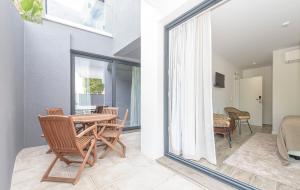 a room with a table and chairs and a balcony at Estoril Village Guest House in Estoril