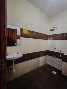 a bathroom with a sink and a shower at Luxury holiday apartments in Mombasa