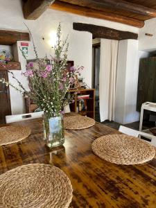 a vase of flowers sitting on top of a wooden table at Casa do Olho d'Água in Portalegre +42 photos