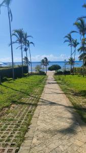 a path with palm trees and the ocean in the background at Sultan Palace in Mombasa