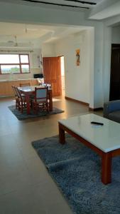 a living room with a coffee table and a kitchen at Sultan Palace in Mombasa