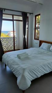 a large white bed with a view of the ocean at Sultan Palace in Mombasa