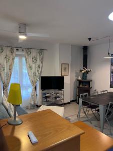 a living room with a tv and a table at Agriturismo Buranco in Monterosso al Mare