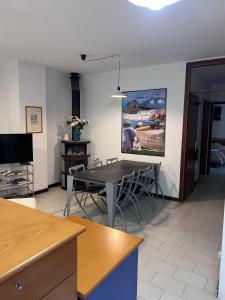 a dining room with a table and chairs and a tv at Agriturismo Buranco in Monterosso al Mare