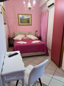 a bedroom with a bed and a table and a chair at Agriturismo Buranco in Monterosso al Mare