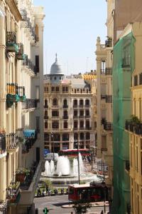 a building with a fountain in the middle of a city at Victoria Site-Luxury Center in Valencia