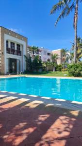 a swimming pool in front of a building at Sultan Palace in Mombasa +4 photos