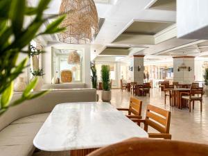 a dining room with a table and chairs and tables at The Breakers Diving and Surfing Lodge Soma Bay in Hurghada