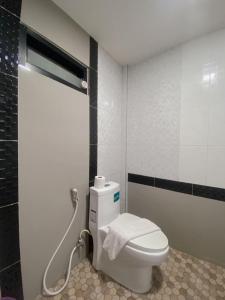 a bathroom with a toilet and a shower at The Coco Grand Chalet in Satun