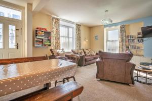 a living room with a couch and a table at Finest Retreats - No 62 at Gadlys House in Beaumaris