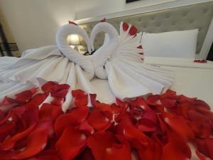 Voodi või voodid majutusasutuse Luxor Boutique Hotel toas